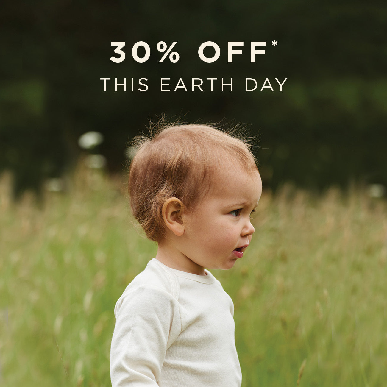 Child in a field with text overlay '30% OFF* THIS EARTH DAY'